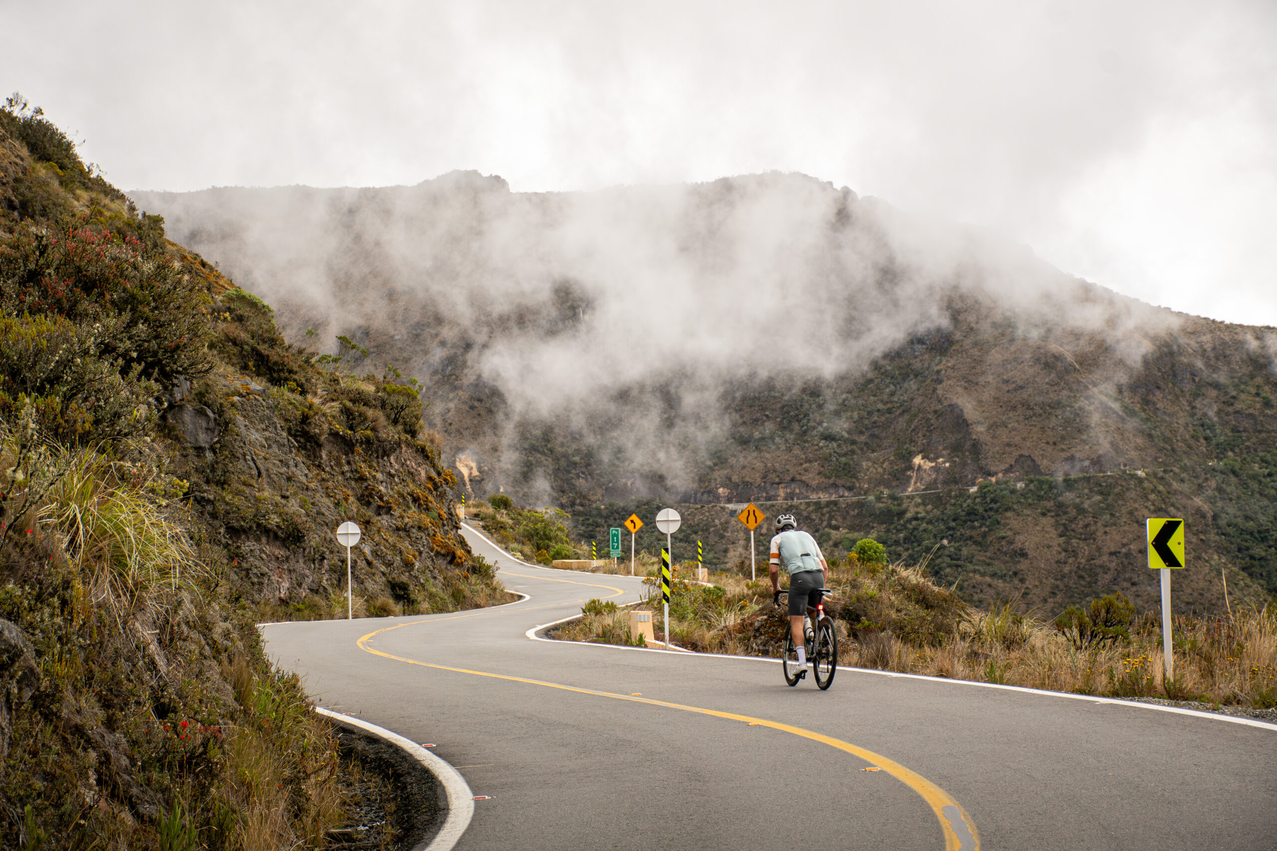 Cyclist climbing Alto de Letras, Colombia, one of the world's longest road cycling climbs.
